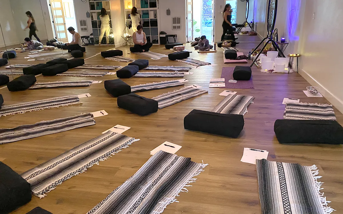 Blankets, bolsters and worksheets laid out for a workshop at Serenity Hot Yoga